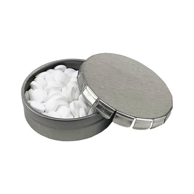 A silver mint tin with a metallic finish, partially open, filled with white mint tablets.
