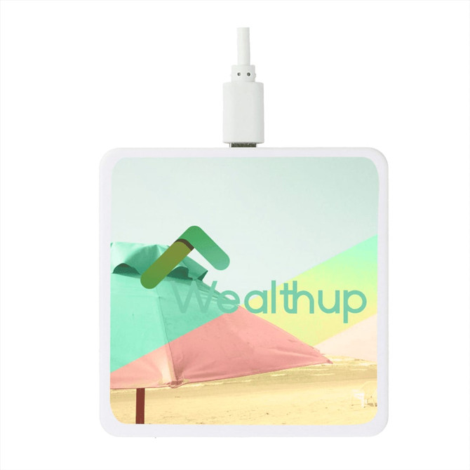 A square wireless charging pad in white with a colourful beach umbrella graphic and a branding logo.