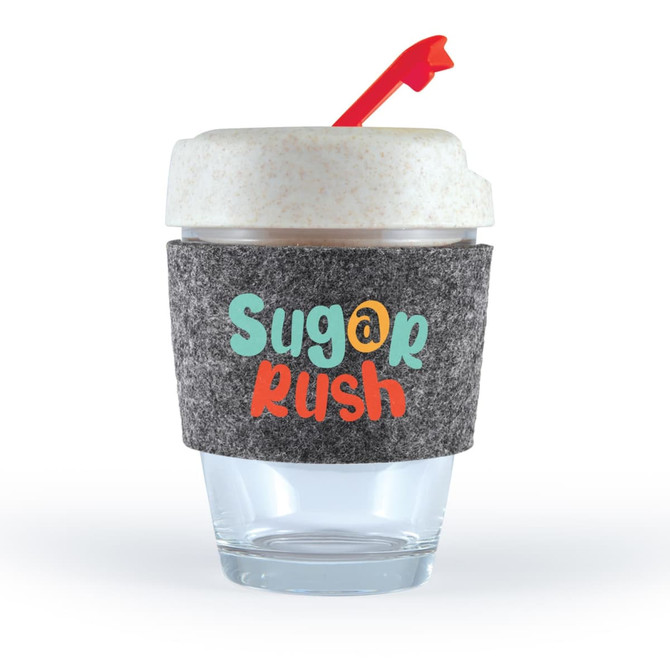 A reusable coffee cup in clear glass with a grey RPET band and a red straw. It features colorful text.