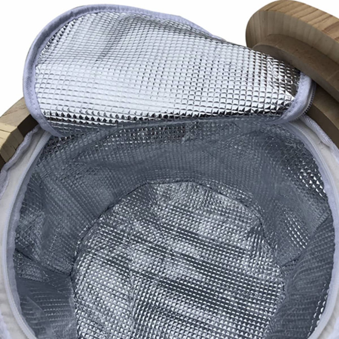 A round picnic cooler basket with a silver insulated interior and a wooden rim. It features a reflective lid.