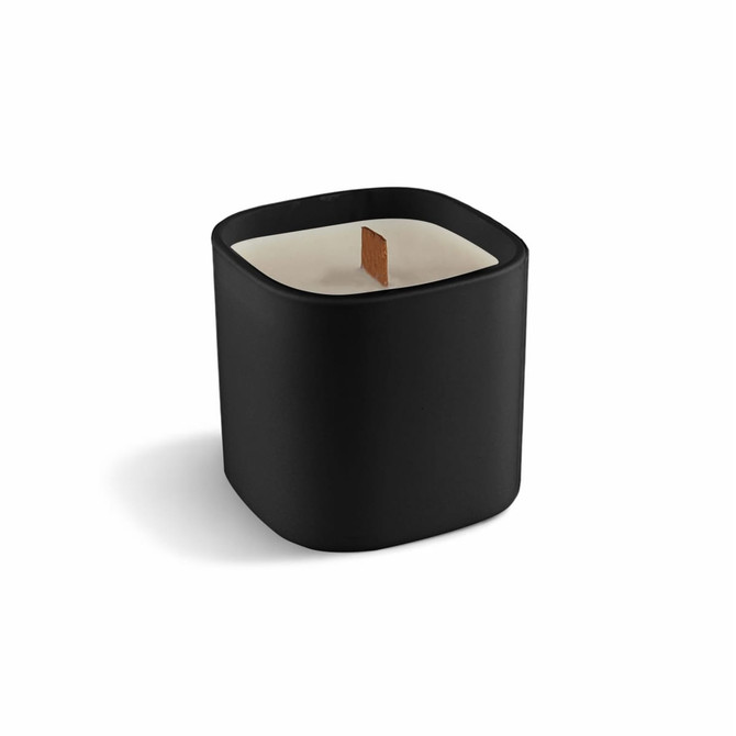 A premium square glass candle in a sleek black container with a wooden wick.