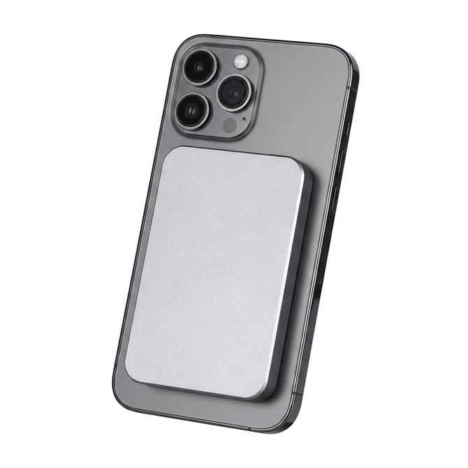 A silver power bank attaches magnetically to the back of a grey smartphone, featuring a sleek design.