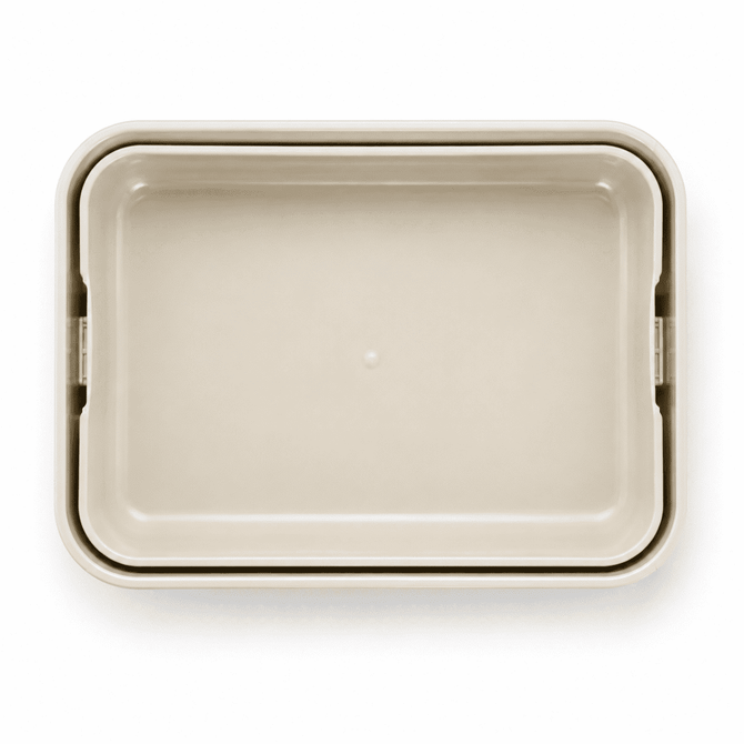 A light beige rectangular lunchbox with a smooth surface and rounded edges. It features a logo.