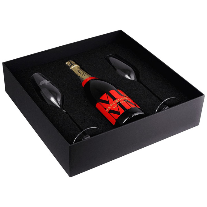 A black gift box containing a bottle of champagne and two elegant glass flutes.