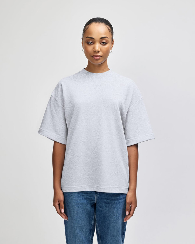 A grey oversized unisex boxy top made from French terry fabric, featuring short sleeves and a round neckline.