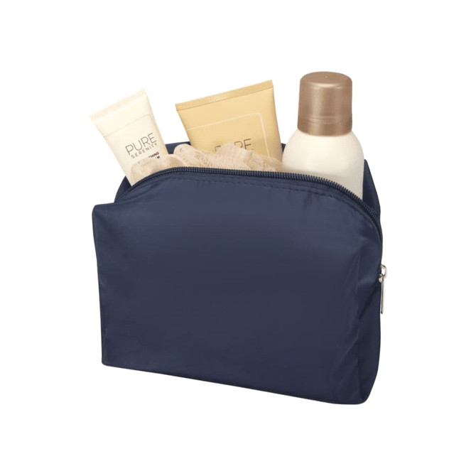 A navy toiletry bag containing various skincare products, including tubes and a bottle, with a textured item inside.