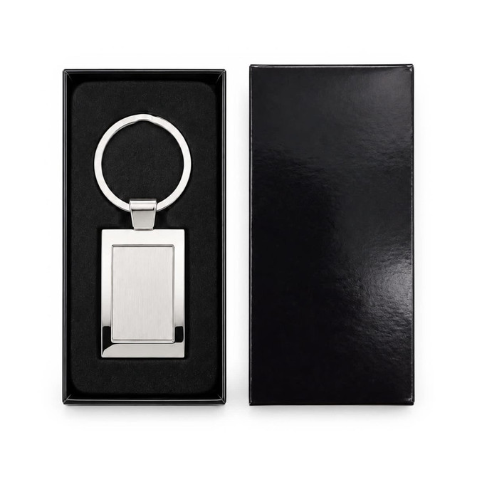 A stainless steel keytag with a rectangular frame, presented in a sleek black box with a soft interior.