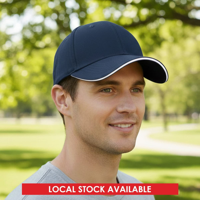 A navy blue cap with a white trim and a logo, set against a natural, green outdoor background.