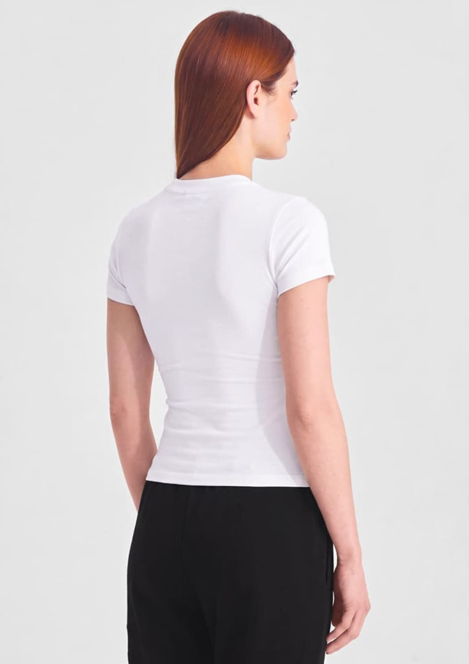 A white women's baby tee displayed from the back, featuring a fitted design and short sleeves.