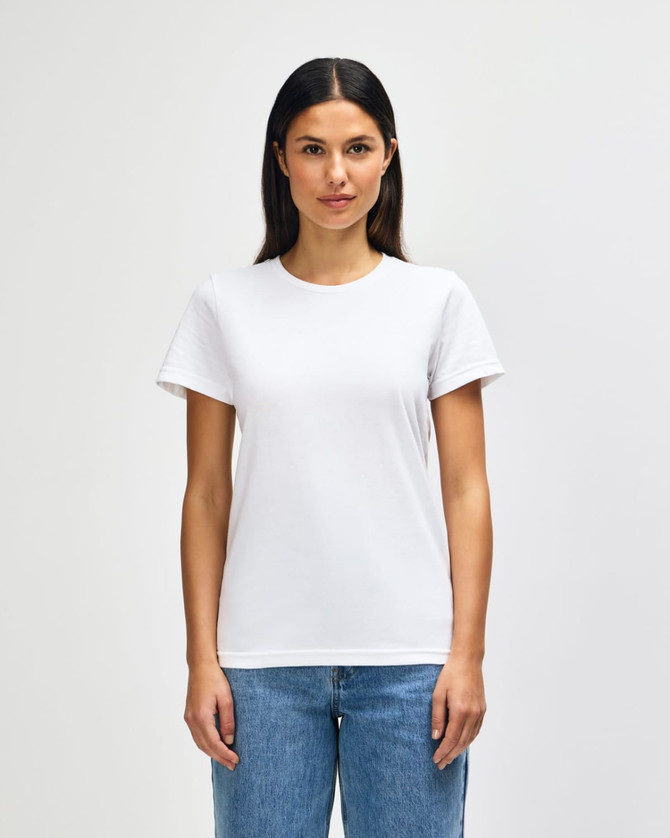 A white midweight t-shirt for ladies, featuring a classic fit and short sleeves. The model is wearing jeans.