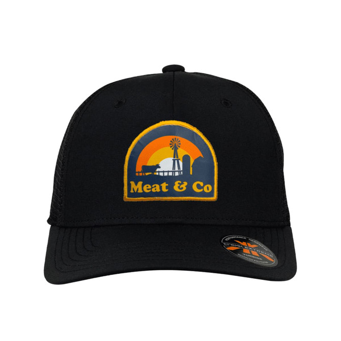A black trucker cap featuring a logo with a sunset, windmill, and text, "Meat & Co".