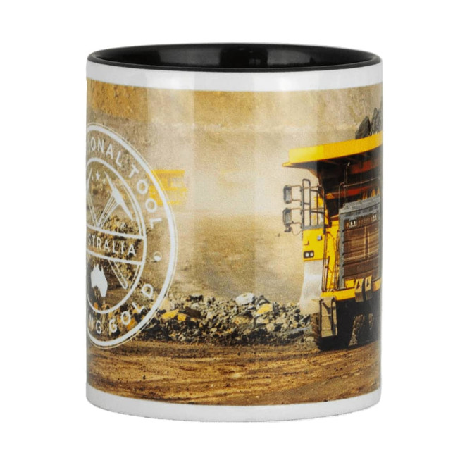 A ceramic mug with a black interior, featuring a construction vehicle design and a logo. The exterior showcases earthy tones.