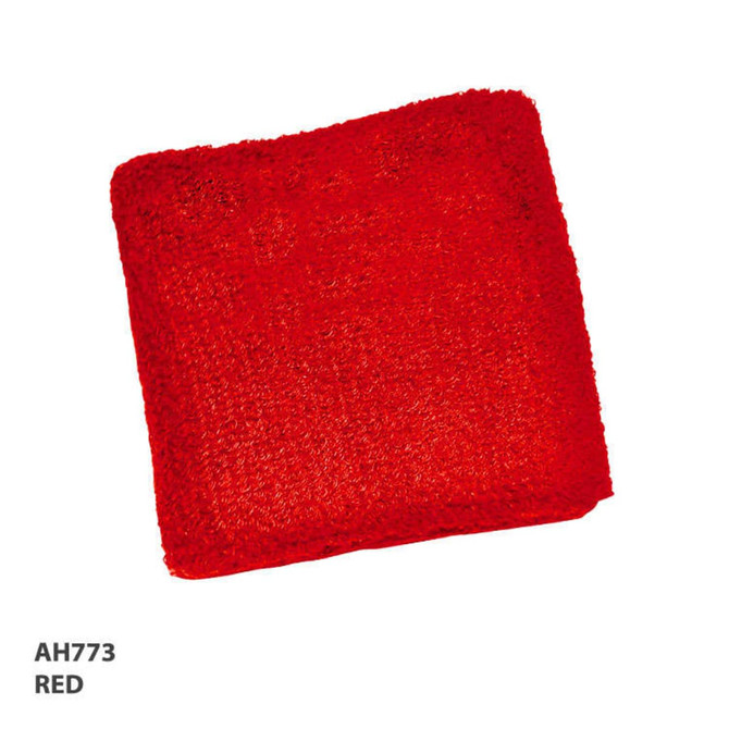 A red wrist band made of textured material, featuring a logo.