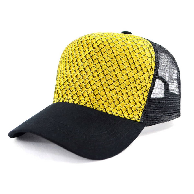 A trucker cap in yellow with a patterned front and black mesh sides. It features a curved brim and a logo.