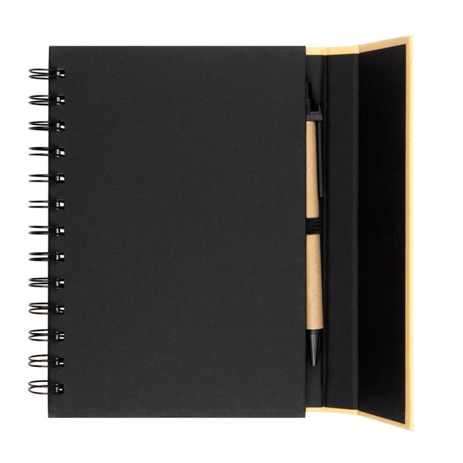 A black spiral-bound notebook with a pen positioned inside. The notebook has a smooth cover and a plain interior.