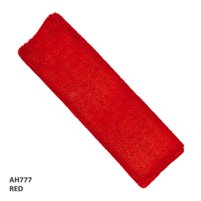 A red headband with a textured surface, featuring a logo at one end.