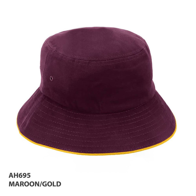 A maroon bucket hat with a gold trim and a logo on the side.