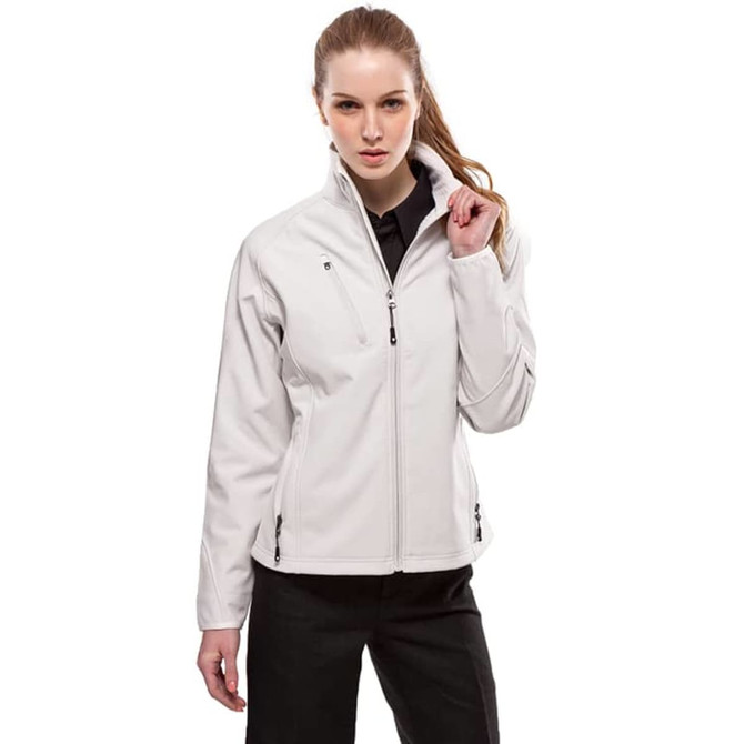 A woman is wearing a light grey Vista Jacket. The jacket features a high collar and zippered pockets.
