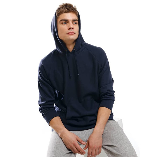 A navy hoodie with a drawstring hood, worn by a man seated on a white surface, paired with grey pants.