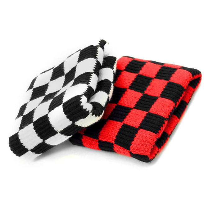 Checkered wristbands in black and white and red and black patterns, stacked on top of each other.