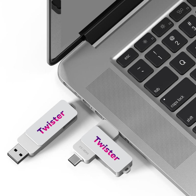 A Twister Type-C flash drive in silver is plugged into a laptop, showcasing a sleek design and branding.