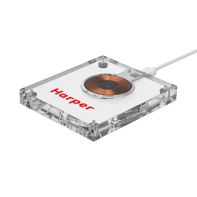 A clear acrylic wireless charger with a circular charging pad and a logo on its surface.