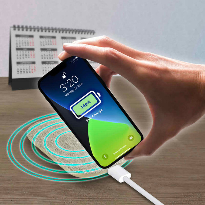 A wireless charger with a textured surface is shown with a smartphone indicating a full charge. It has a light colour scheme.