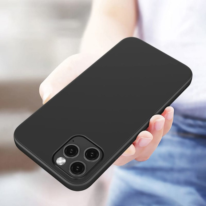 A black TPU iPhone case held in a hand, showcasing its sleek design and cutouts for camera lenses.