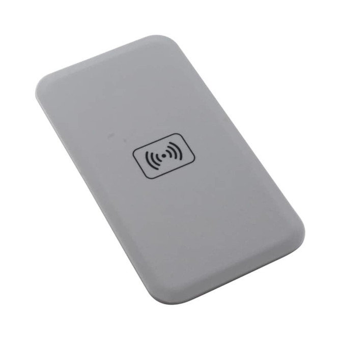 A wireless charger in a sleek grey design with a logo on the surface.