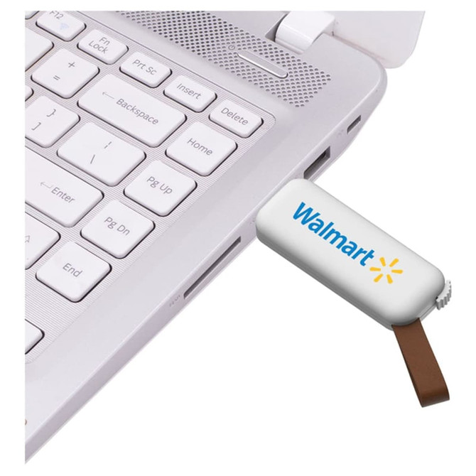 A white flash drive with a brown connector plugged into a laptop, featuring a logo on the drive.