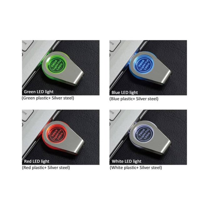 A collection of four flash drives with different LED light colours: green, blue, red, and white, on a silver background.