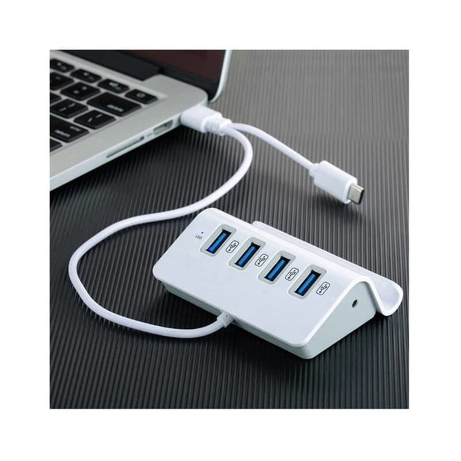 A white USB hub with five ports connected to a laptop, featuring a sleek design and a USB-C cable.