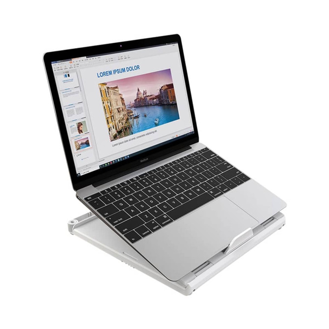 A foldable laptop stand in silver, supporting a laptop displaying a presentation on a white background.