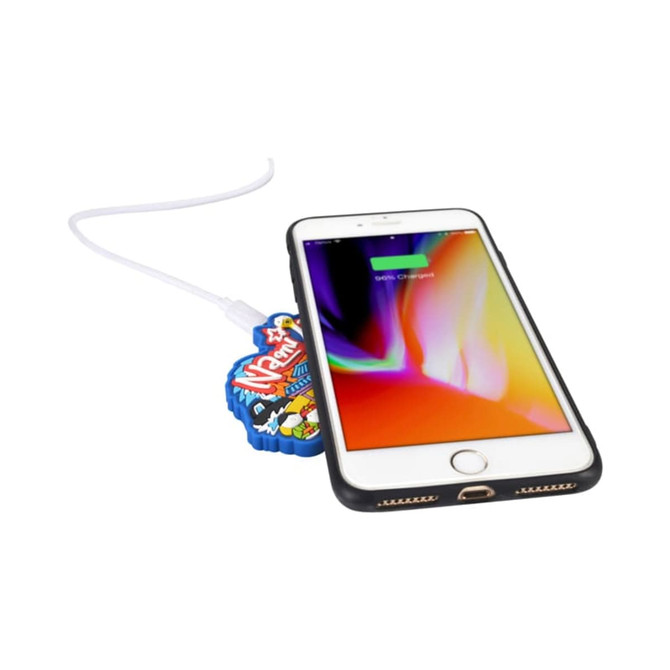 A custom moulded wireless charger in vibrant colours, with a smartphone partially on it, connected by a charging cable.