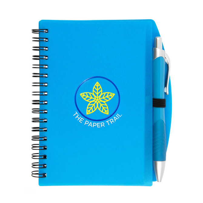 A blue spiral notebook with a pen, featuring a logo on the cover and a black pen holder on the side.