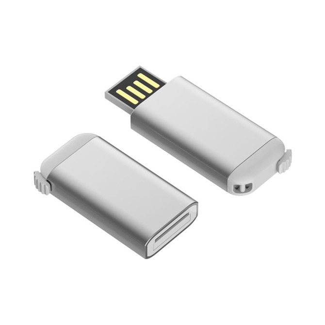 A silver flash drive with a detachable cap and a USB connector, featuring a logo on its surface.
