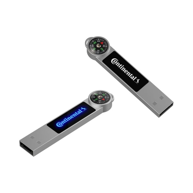 A silver Atlas LED flash drive featuring a compass on one end and a logo on the side.