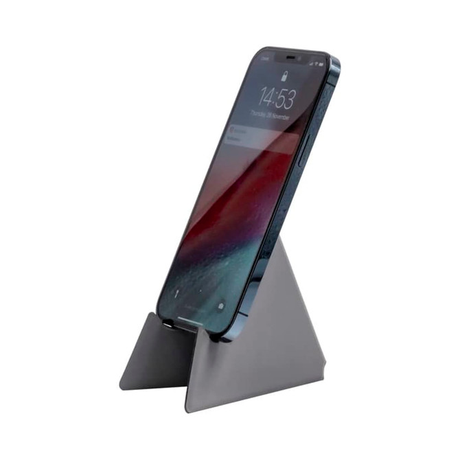 A grey phone stand displaying a smartphone in an upright position, featuring a simple triangular design.