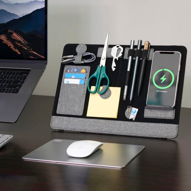 A laptop organiser in grey featuring compartments for stationery, a phone holder, and a wireless charging pad.