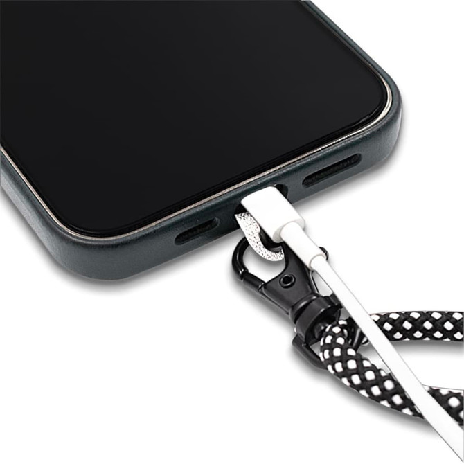 A close-up of a phone with a black and white patterned crossbody strap attached, featuring a connector at the base.