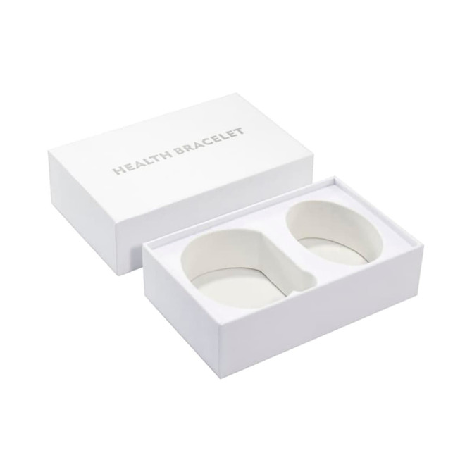 A large white gift box containing two health bracelets, featuring a simple, elegant design.
