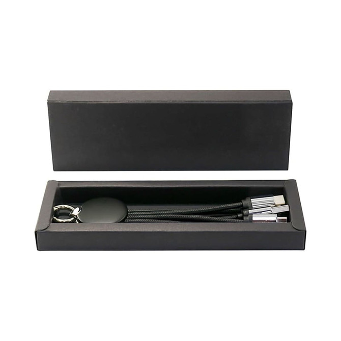 A black gift box containing three braided charging cables and a circular keychain. The box features a sleek design and has a logo.