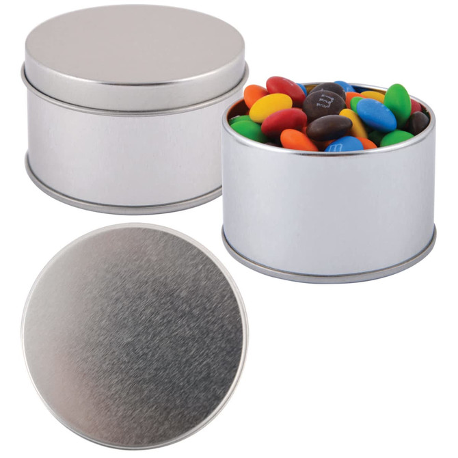 A silver round tin filled with colorful M&M's candies, featuring a smooth metal lid.