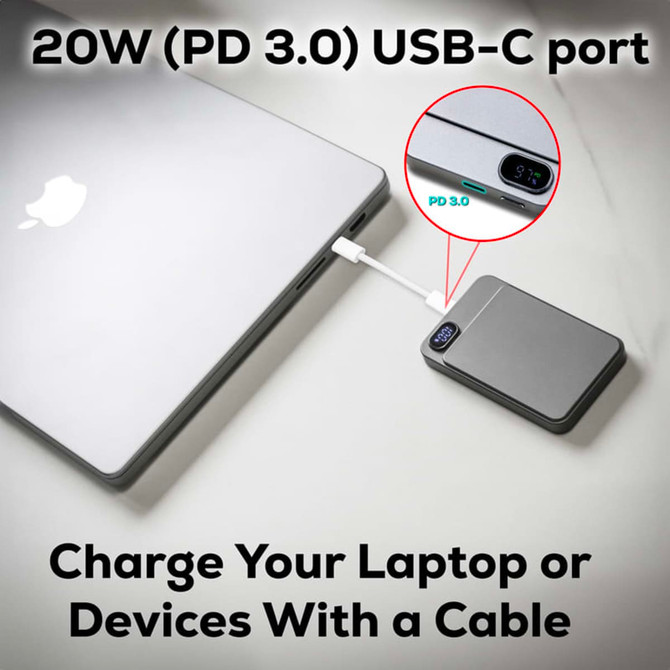 A sleek grey power bank with a USB-C port connected to a laptop, featuring a small display.