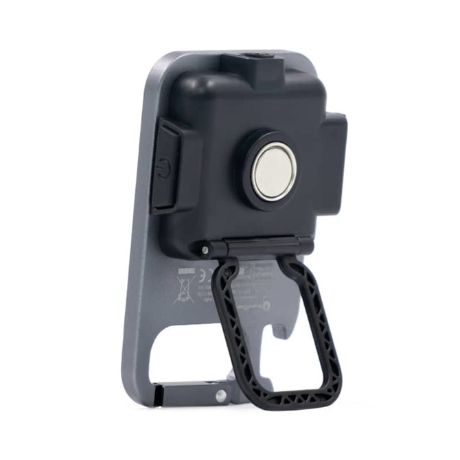 A black and grey multi-tool with a handle, featuring a button and a magnet on the back. It has a logo present.