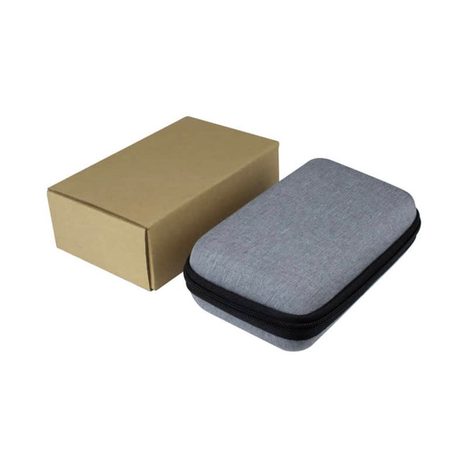 A grey zippered case with a cardboard box beside it. The case is compact and rectangular in shape.