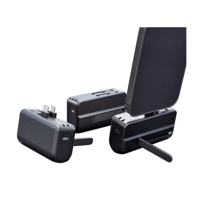 A black Genoa Capsule Power Bank Stand with a foldable support and multiple ports for charging devices.