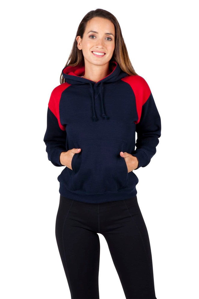 A woman wearing a navy and red shoulder contrast panel hoodie with a pocket and hood. The hoodie has a logo.