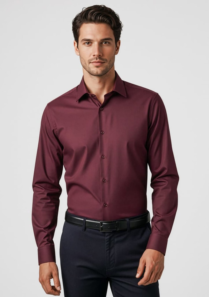 A maroon long sleeve button-up shirt with a fitted design and a logo. Styled with dark trousers.