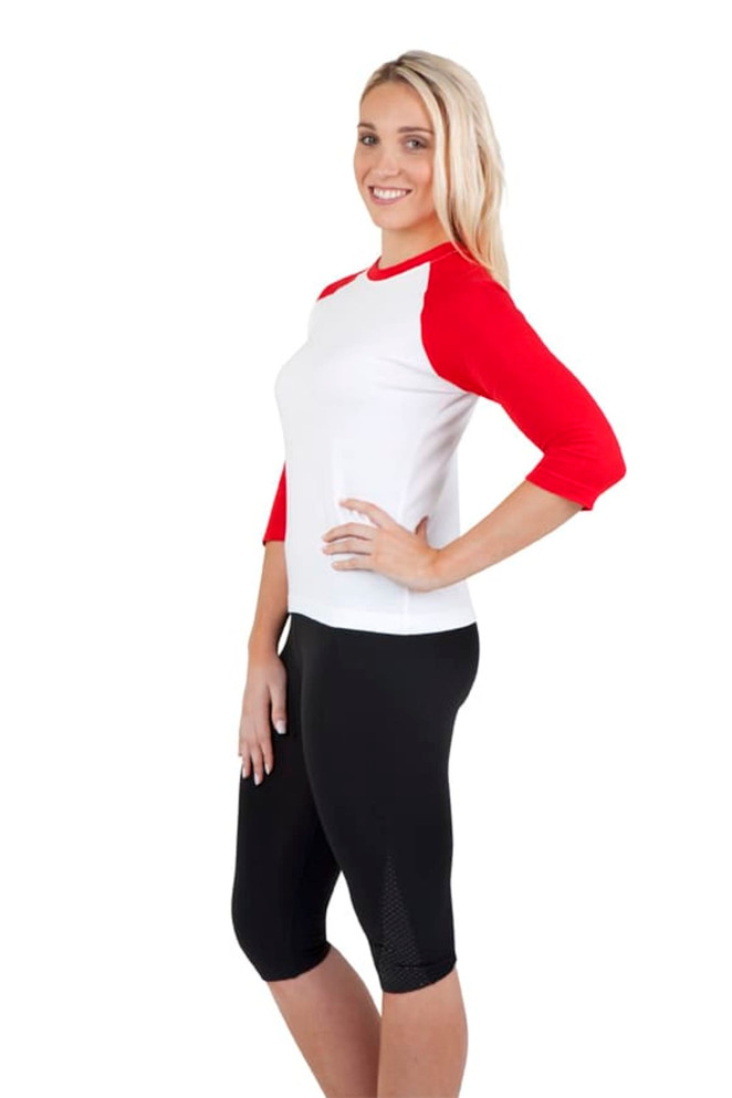 A women's 3/4 sleeve raglan T-shirt featuring red sleeves and a white body, paired with black shorts.